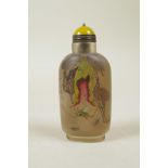 A Chinese reverse decorated glass snuff bottle depicting insects and fruit, 3½" high