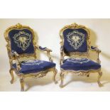 A pair of Continental style carved giltwood open armchairs, the covers with metal thread embroidery