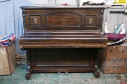 A John Brinsmead and Sons upright piano, with a rosewood case and iron frame, 56" x 26" x 51"