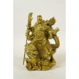 A Chinese gilt metal figure of a warrior Immortal and dragon, 8½" high