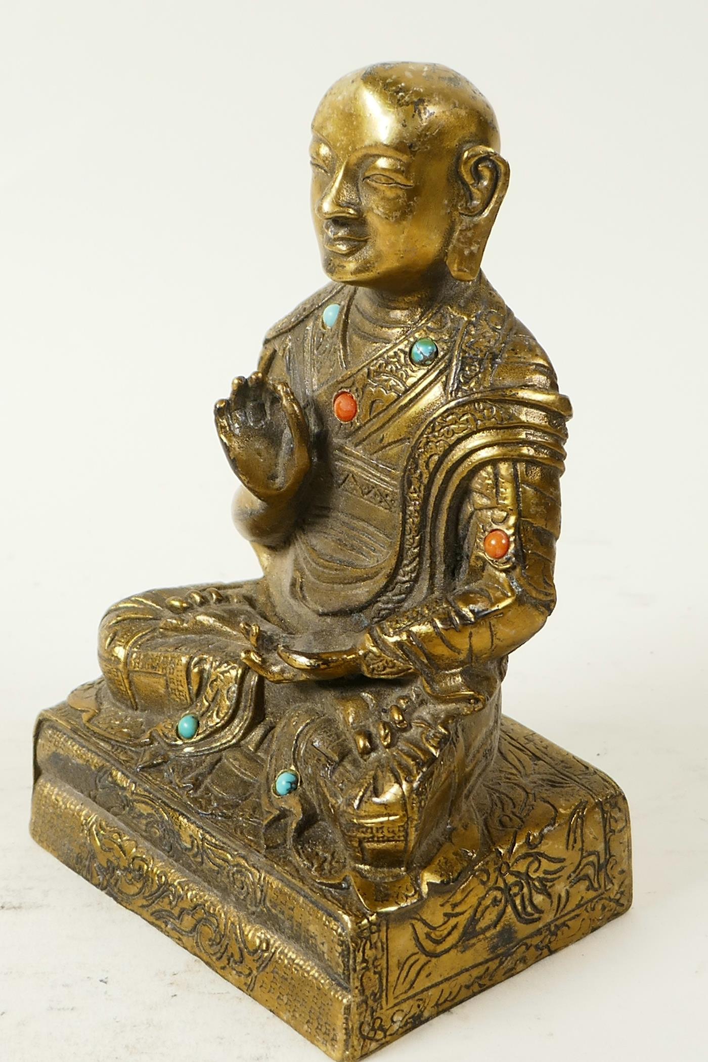A Sino-Tibetan brass figure of Buddha seated in meditation having engraved decoration and set with - Image 3 of 5