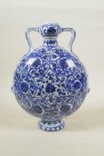 A Chinese blue and white porcelain garlic head shaped flask with two handles decorated with a