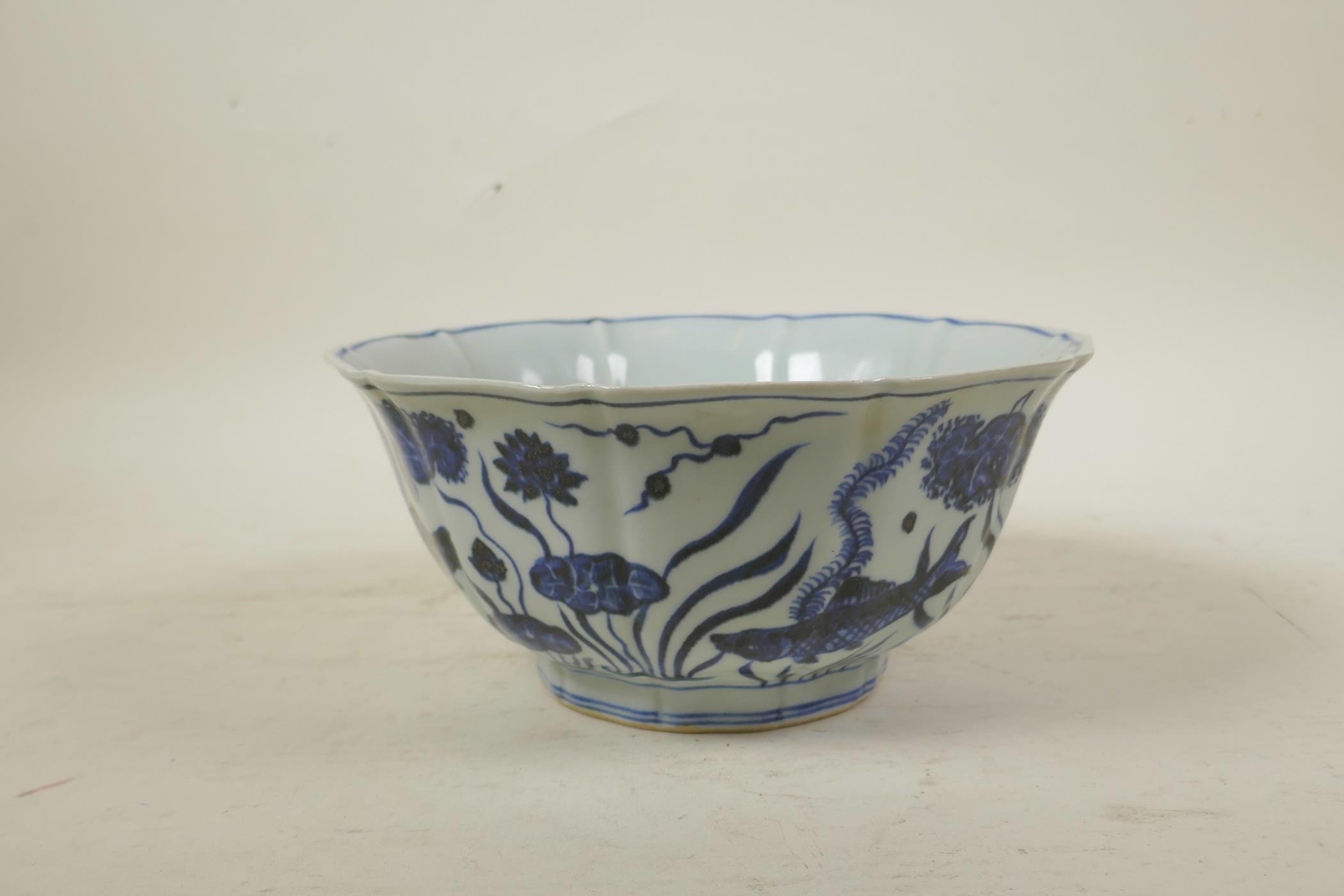 A Chinese Ming style blue and white porcelain bowl of lobed form, decorated with carp in a lotus - Image 5 of 7