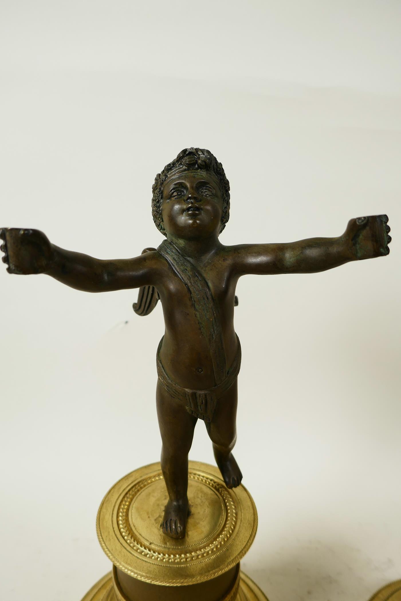 A pair of bronze cherubs cast with outstretched arms mounted on French marble and ormolu Empire - Image 4 of 5