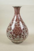 A Chinese red and white porcelain pear shaped vase, with scrolling lotus flower decoration, 12"
