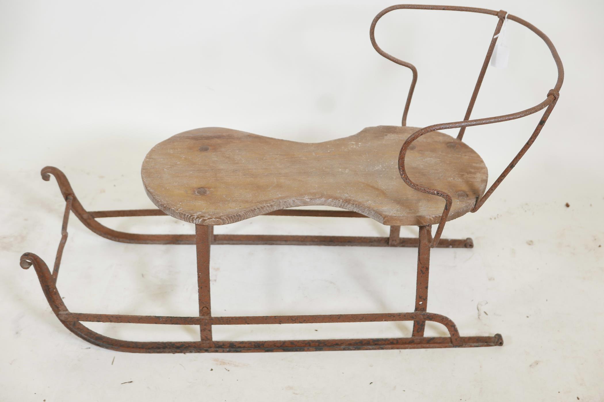 An antique child's sled, wrought iron with a wood seat, 32" x 20"high - Image 2 of 3