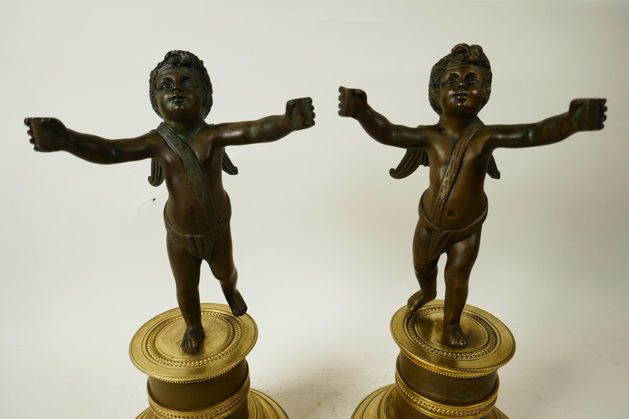 A pair of bronze cherubs cast with outstretched arms mounted on French marble and ormolu Empire - Image 2 of 5