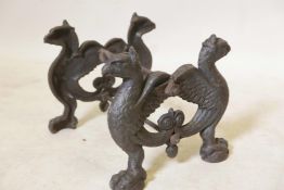 An antique cast iron bootscraper with winged griffin supports, 12" x 10" x 9"