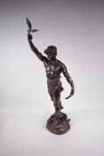 A bronze figure of a victorious male athlete, standing on a naturalistic base with vanquished