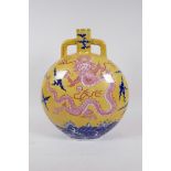 A Chinese yellow ground porcelain two handled moon flask decorated with a red dragon and blue