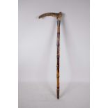 An early C20th child's bamboo walking stick with an antler handle and hallmarked silver cuff (
