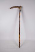 An early C20th child's bamboo walking stick with an antler handle and hallmarked silver cuff (