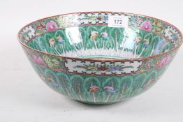 A Chinese famille verte porcelain bowl, decorated with butterflies and roses in bright enamels,