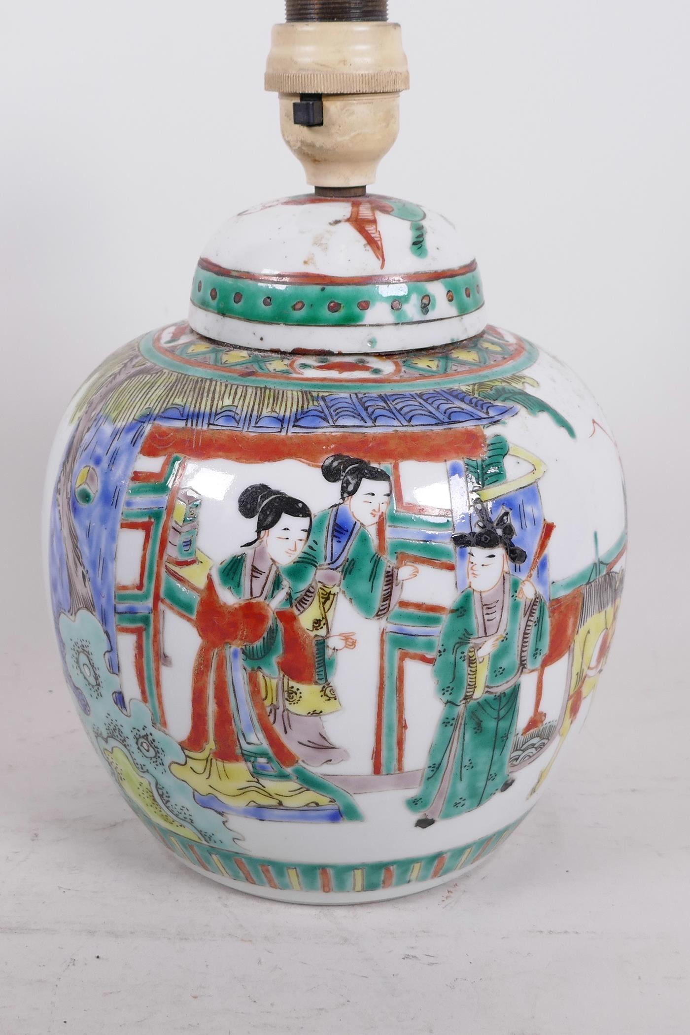 A Chinese famille verte ginger jar and cover converted to a lamp, painted with travellers on the