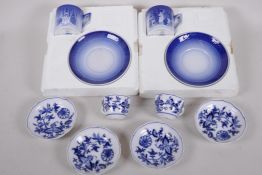 Two early Meissen 'Onion' pattern coffee cups with four saucers, together with two Royal