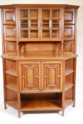 A Victorian walnut two part side cabinet, the upper section with bevelled glass door, the base