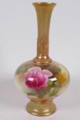 A Royal Worcester porcelain bud vase with blush body painted with roses, long neck and foot enhanced