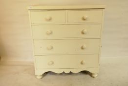 A Victorian painted chest of two over three drawers, with shaped apron, raised on tulip supports,