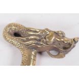 A Chinese brass walking stick handle cast as a dragon, 5" wide