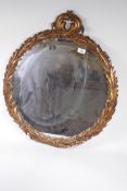 A vintage circular wall mirror with moulded acanthus leaf gilt frame, 25" diameter