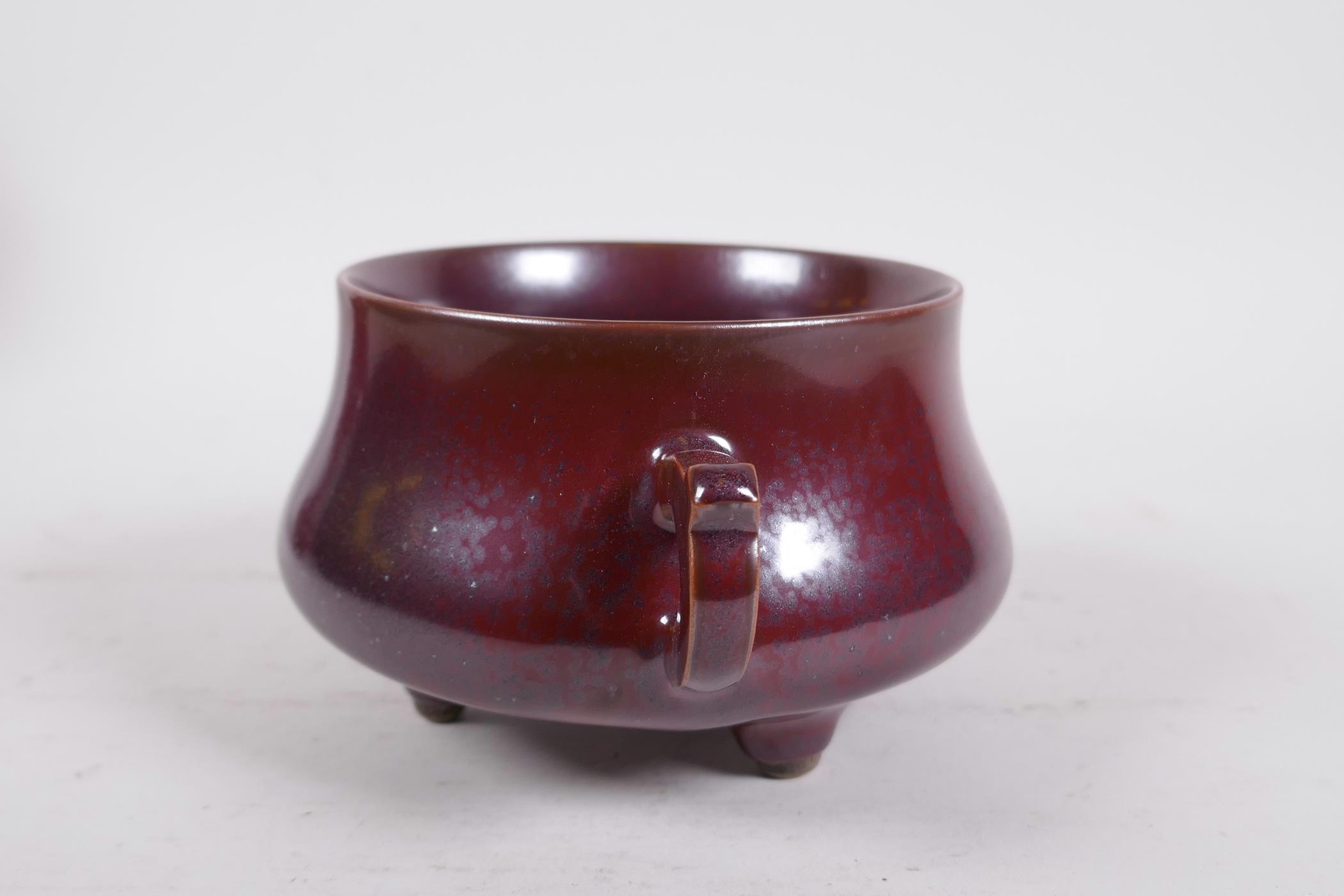 A Chinese iridescent copper glazed porcelain censer raised on tripod supports with two handles, - Image 2 of 7