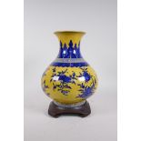 A Chinese yellow ground porcelain vase with blue and white decoration of branches bearing fruit