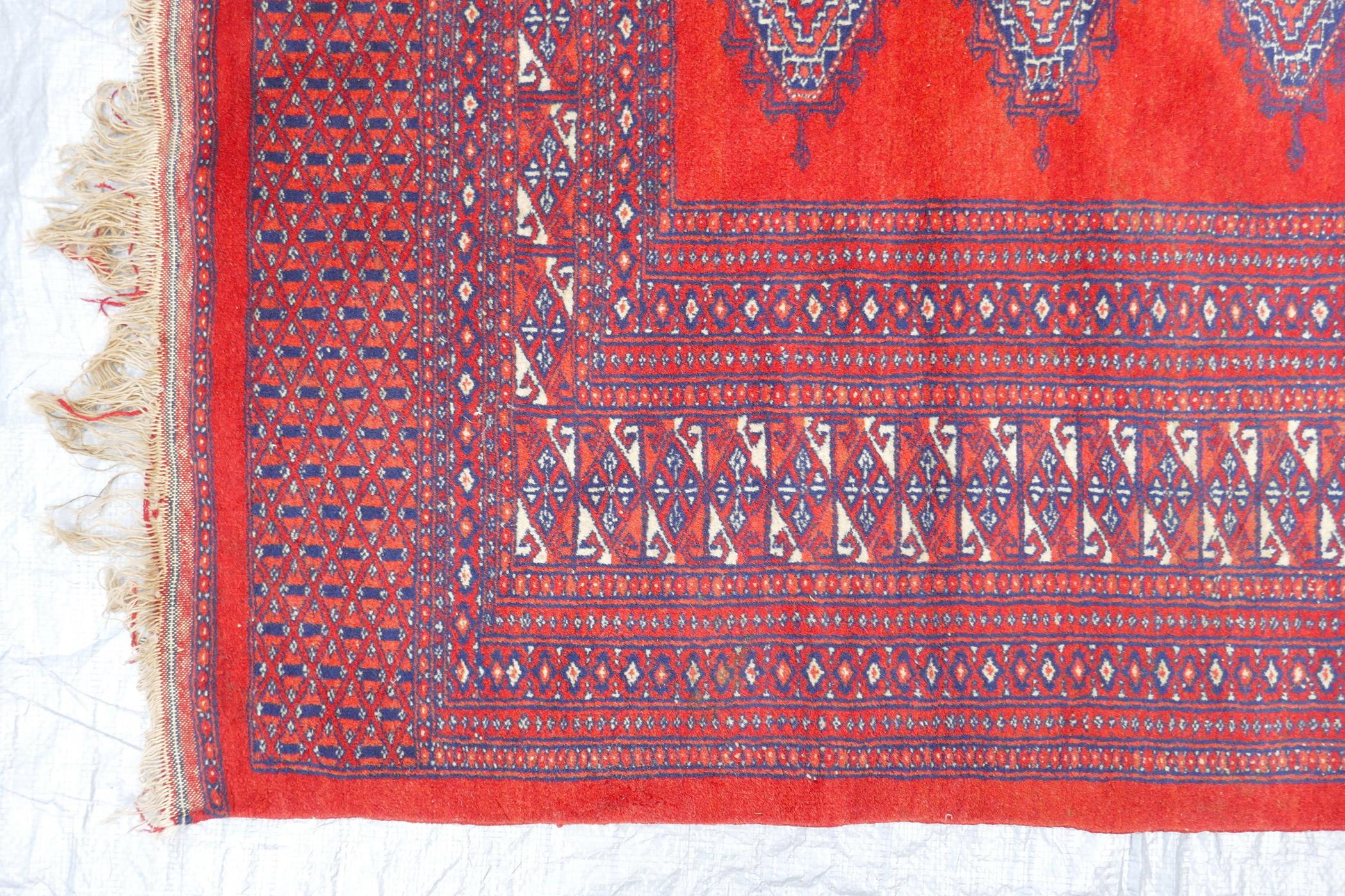 A Turkmen tomato ground wool carpet with a Bokhara design, 51" x 72" - Image 5 of 6