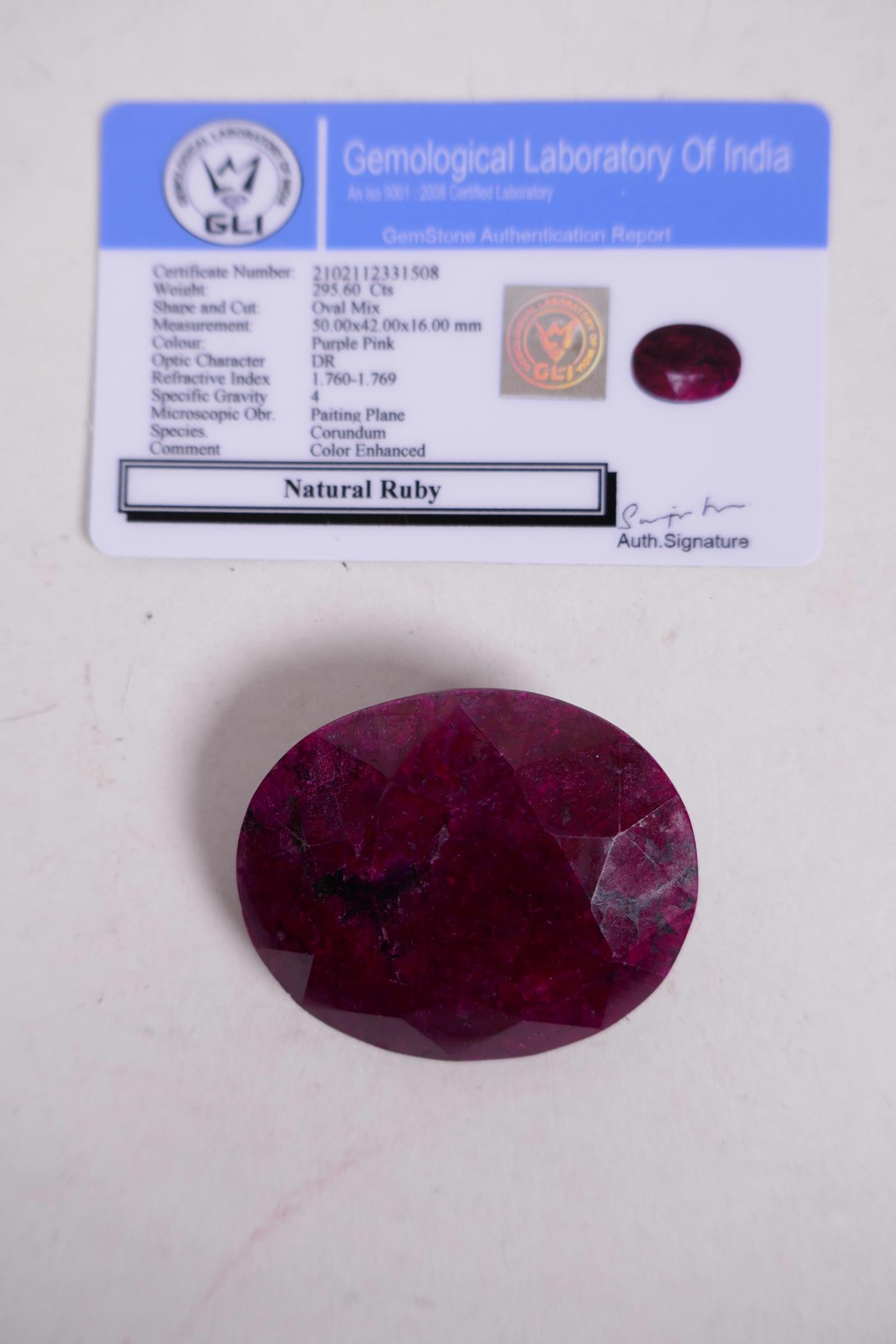 A 295ct natural ruby gemstone, oval cut, with certification from the Gemological Laboratory of India