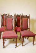 A set of four C19th walnut Art Nouveau high back chairs with shaped splats and carved back rails,