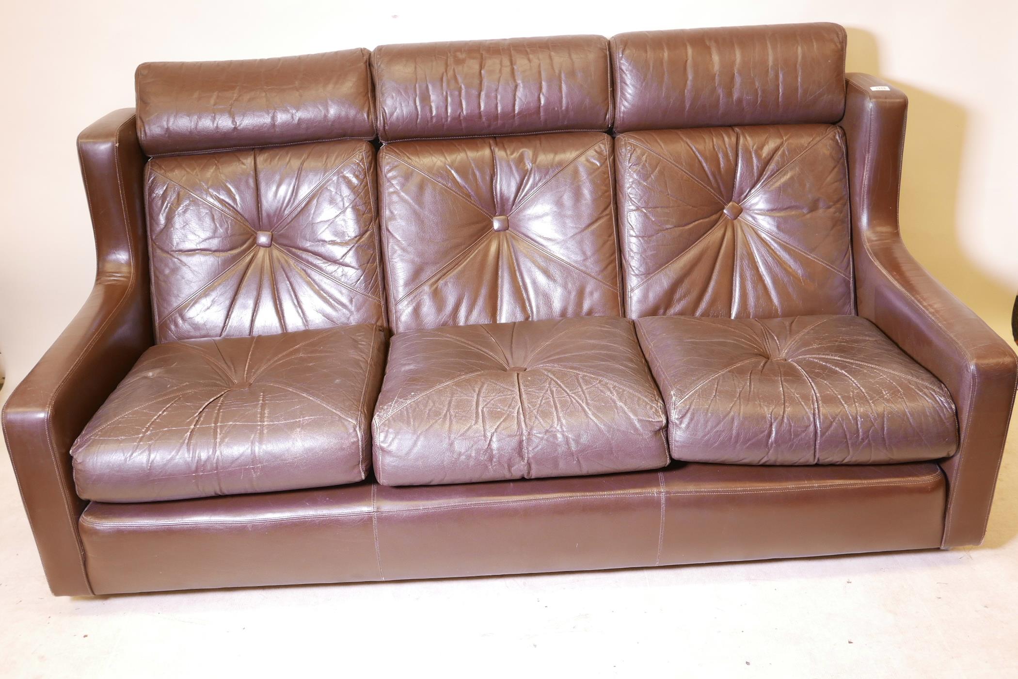 A contemporary three seater brown leather settee, 70" wide