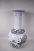 A Chinese famille rose porcelain floor vase, mid C20th, painted with a pair of peacocks, peony