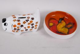 A Poole Pottery orange Delphis bowl, 7" diameter, together with an Arthur Woods Pottery stylised dog