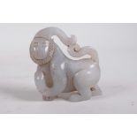 A Chinese carved celadon jade monkey, 3" long