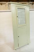 A painted standing corner cabinet, with glazed door over cupboard, 36" x 74"