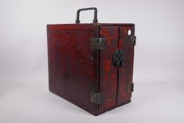 A C19th Chinese lacquered cabinet, the two doors opening to reveal six drawers, with brass hinges