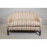 A two seater tub shaped settee with scrolled arms, raised on square moulded supports, 56" wide