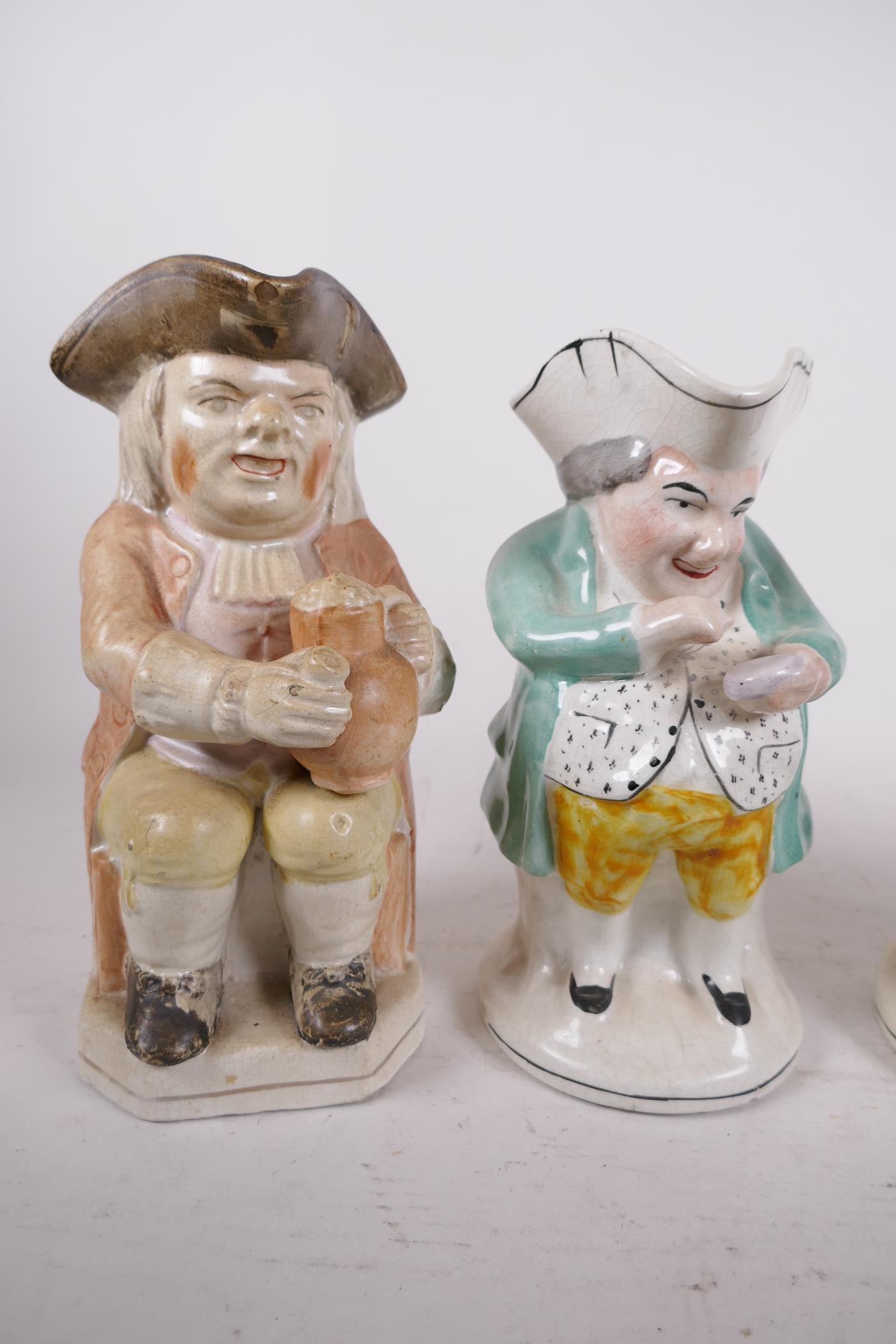 Four antique Staffordshire Toby jugs, a Ralph Wood style 'Toper' and three snuff takers, largest 10" - Image 2 of 3