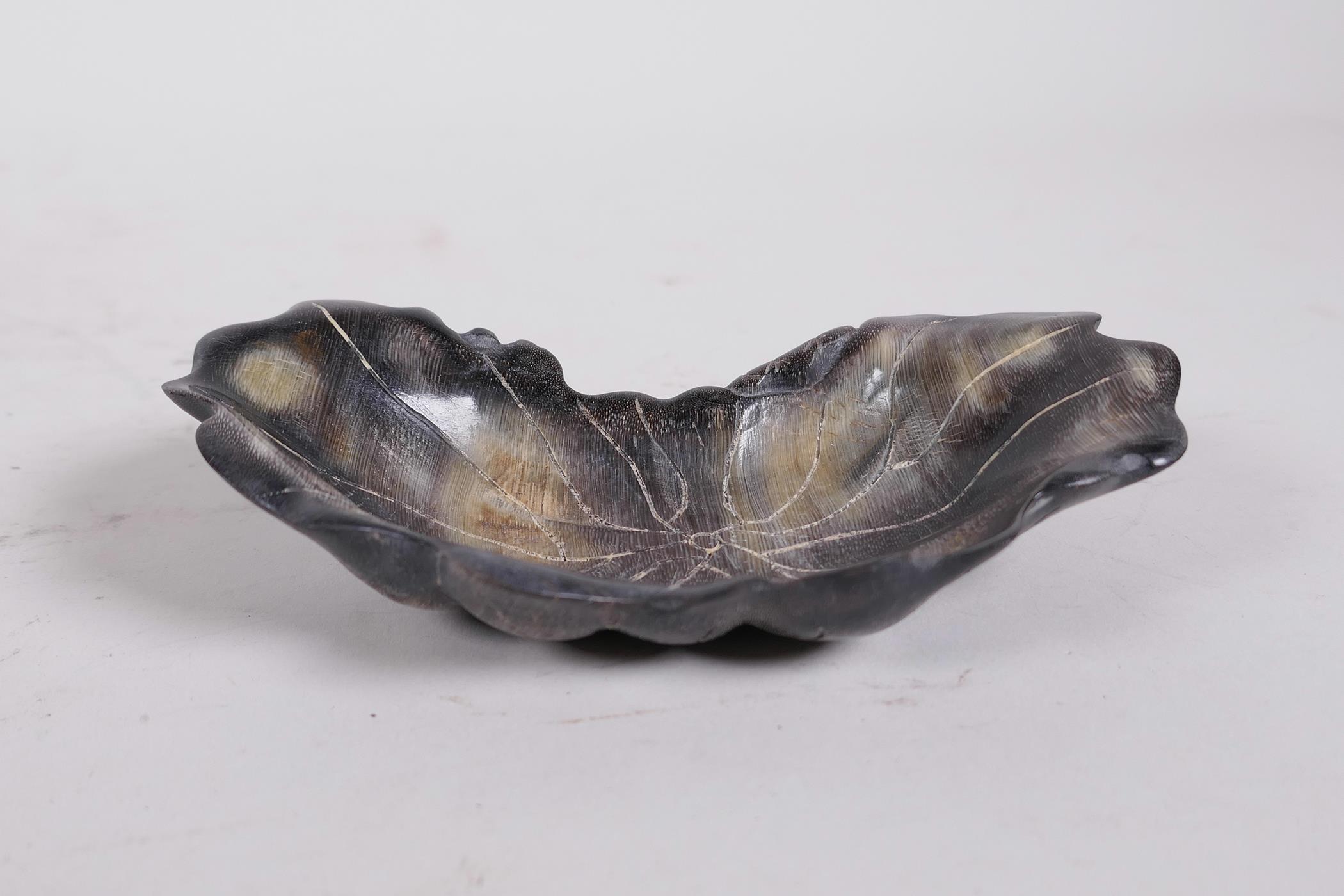 A Chinese carved horn trinket dish in the form of a lily pad, 5" x 2½"