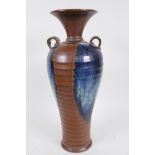 A Chinese Chizu style ribbed pottery vase with two handles and flared neck, with high fired brown