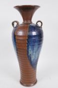 A Chinese Chizu style ribbed pottery vase with two handles and flared neck, with high fired brown