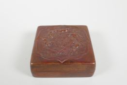 A Chinese pressed and patinated copper trinket box with raised mythical creature decoration,