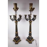 A pair of bronze and ormolu mounted five branch candelabra, converted to electric lamps with