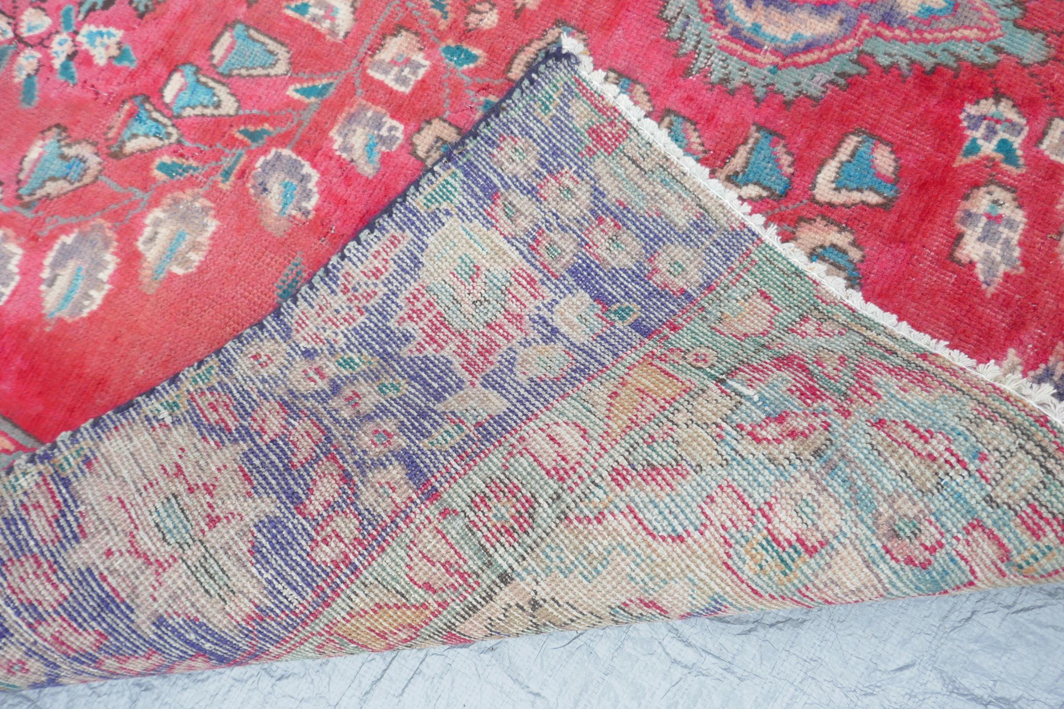 A vintage Iranian carpet from the Tabriz region, with a floral medallion design on a red field - Image 4 of 5