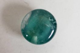 A 46.50ct green fluorite round cabochon, GJSPC certified, with certificate