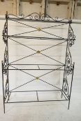 A painted, wrought metal three tier baker's/boulangerie rack, with brass mounts, lacks shelves,