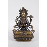 A Sino-Tibetan bronze figure of a four armed Buddha seated on a lotus throne, 8½" high