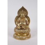 A Chinese gilt filled bronze Buddha seated on a lotus throne, impressed character marks to base,