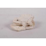 A carved bone netsuke in the form of a toad, 2" long