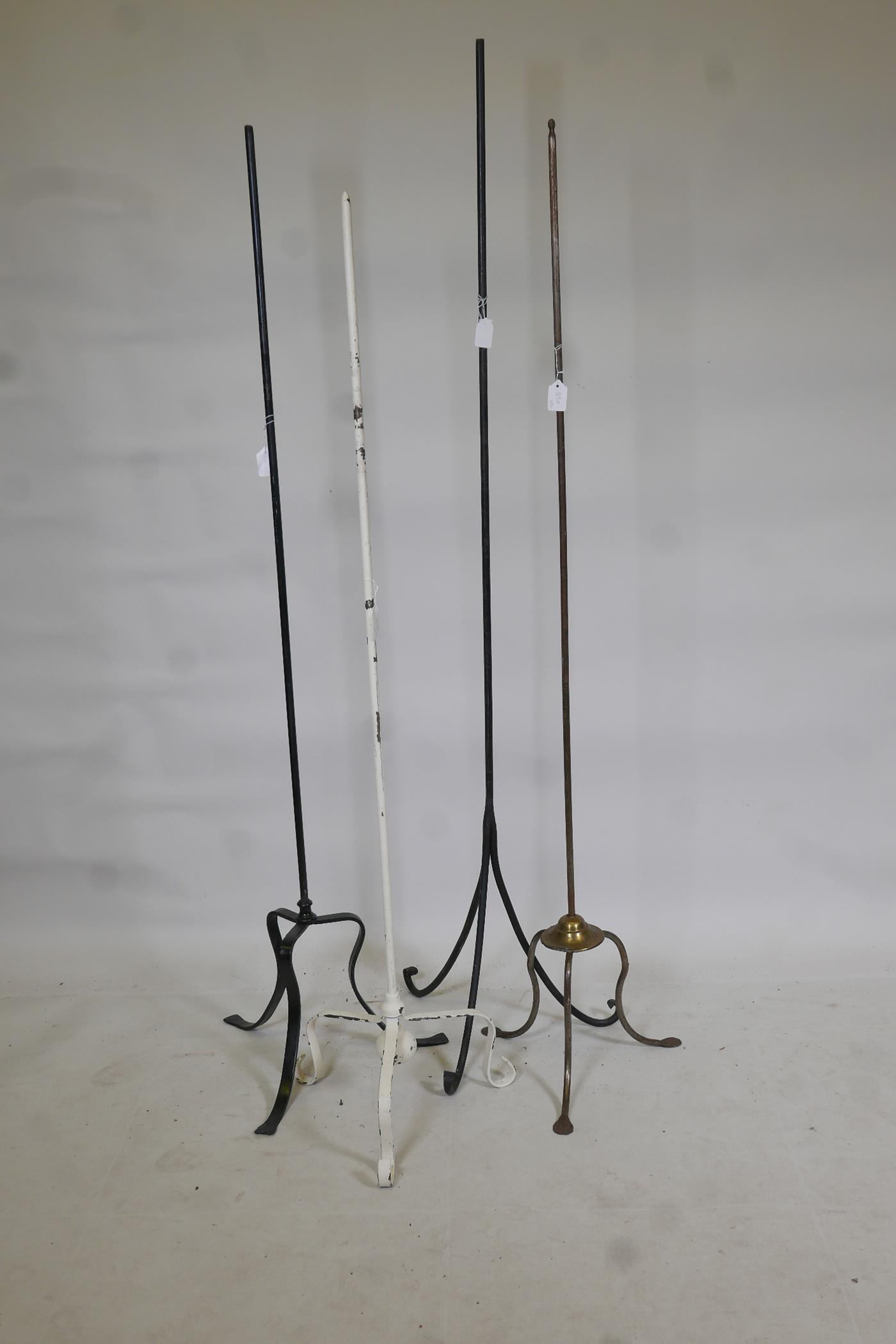 Four metal lamp stands, largest 63" high