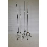 Four metal lamp stands, largest 63" high